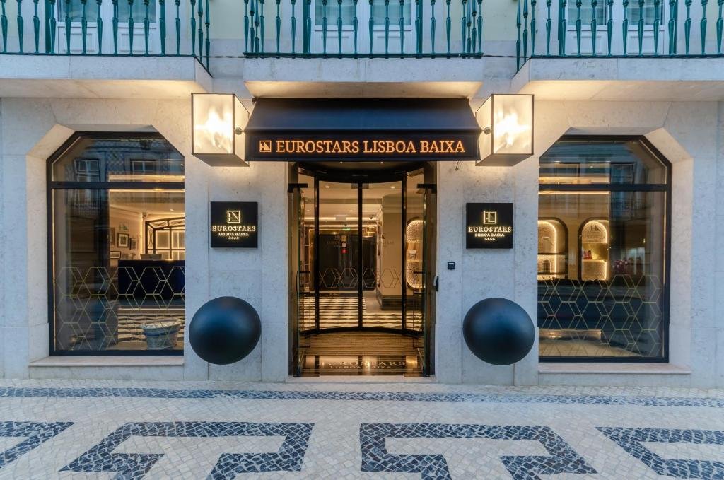 Elegant Eurostars Lisboa Baixa hotel entrance with marble facade and geometric design.