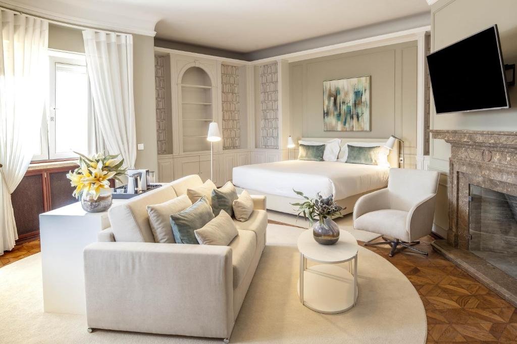 Luxurious hotel suite with modern decor, cozy bed, elegant seating, fireplace, and soft lighting. Perfect for relaxation.