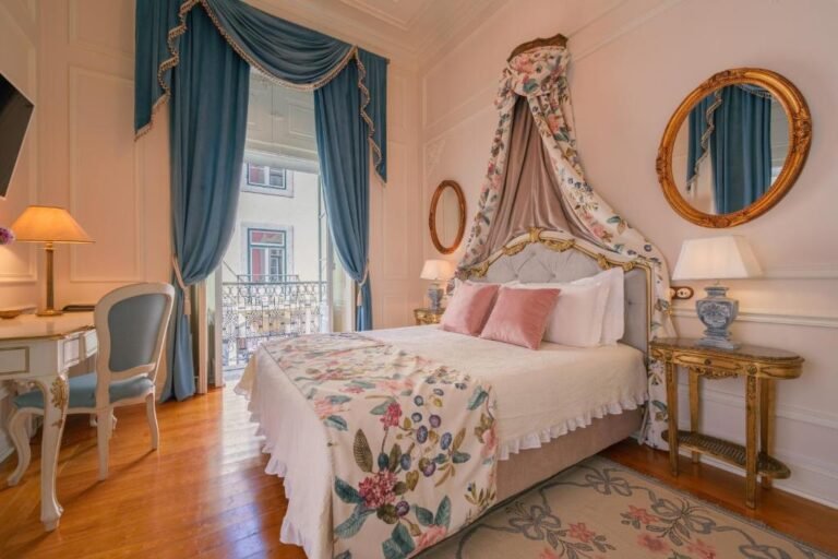 Elegant vintage bedroom with floral canopy bed, blue drapes, and antique decor, exuding luxury and comfort.
