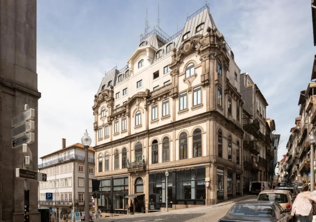 Historic European building with intricate architecture in a bustling urban street setting.